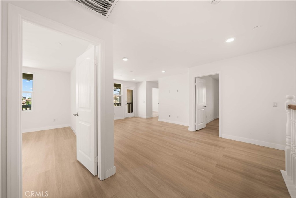 13296 Joliet Drive Rancho Cucamonga, CA 91739 - Photo 18 of 69 a view of a hallway with wooden floor