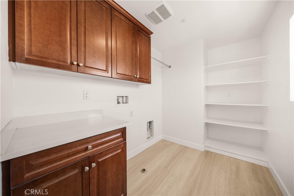 13296 Joliet Drive Rancho Cucamonga, CA 91739 - Photo 32 of 69 a view of a storage and utility room with wooden floor