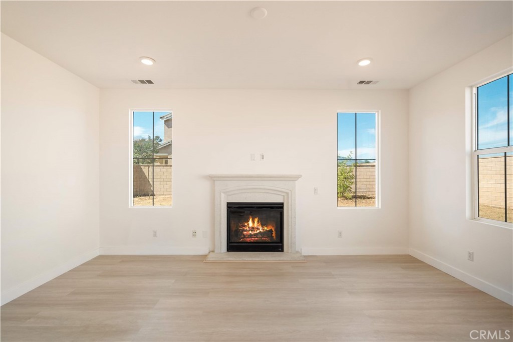 13296 Joliet Drive Rancho Cucamonga, CA 91739 - Photo 5 of 69 a view of an empty room with a fireplace and a window