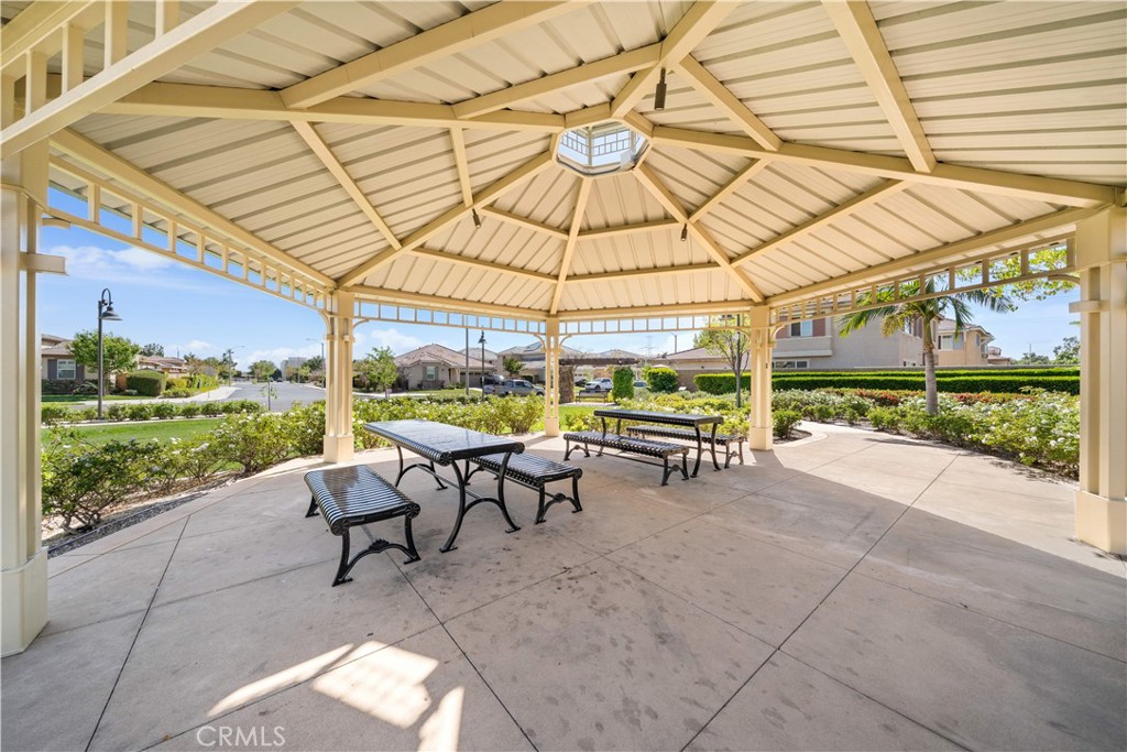 13296 Joliet Drive Rancho Cucamonga, CA 91739 - Photo 59 of 69 a view of a patio with a table and chairs under an umbrella