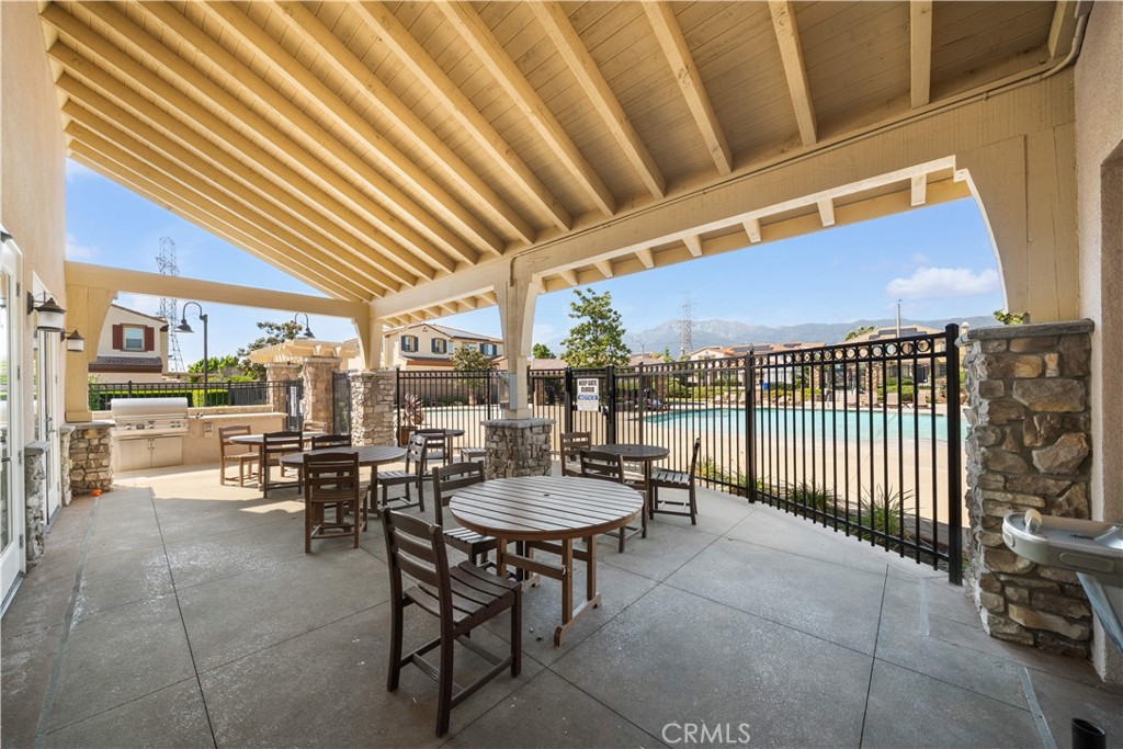13296 Joliet Drive Rancho Cucamonga, CA 91739 - Photo 66 of 69 a view of a patio with a table and chairs and a barbeque
