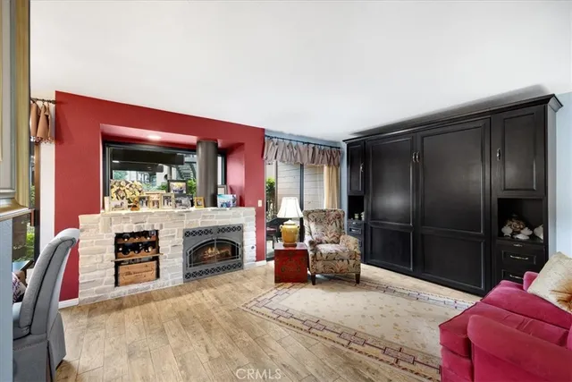 a living room with furniture a flat screen tv and a table