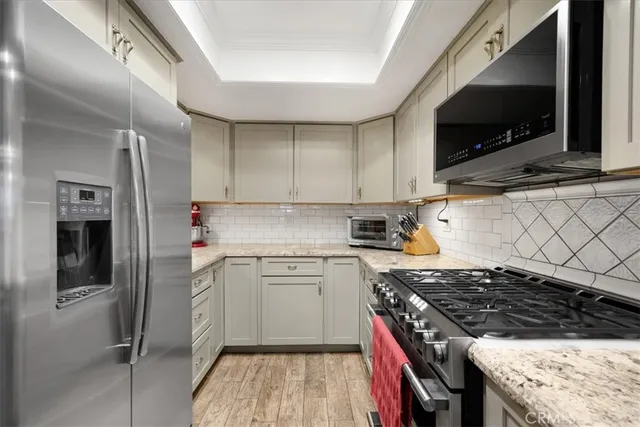 a kitchen with stainless steel appliances granite countertop a stove and a sink