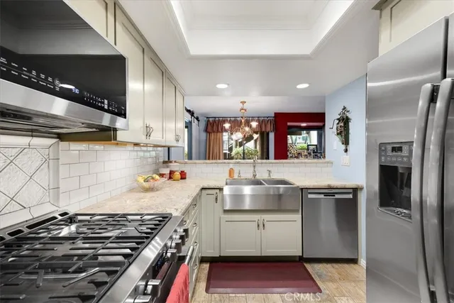 a kitchen with a sink stove top oven and cabinets