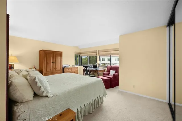 a bedroom with a large bed and a large window