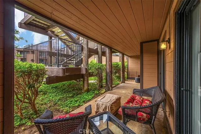 a view of a door and chair and potted plants