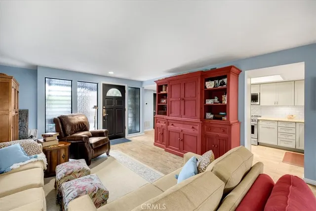 a living room with furniture a fireplace and a dining table with wooden floor