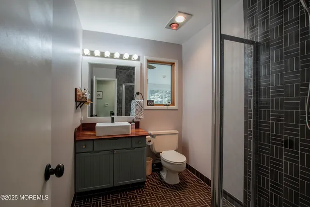 a bathroom with a sink toilet and shower