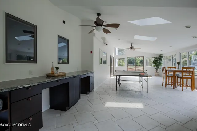 a kitchen with stainless steel appliances granite countertop a sink a stove and a refrigerator