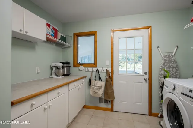 a kitchen with a sink cabinets and a window