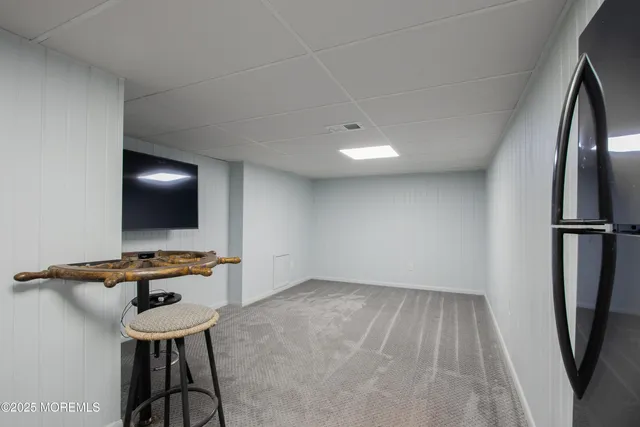 a view of a room with gym equipment and a flat screen tv