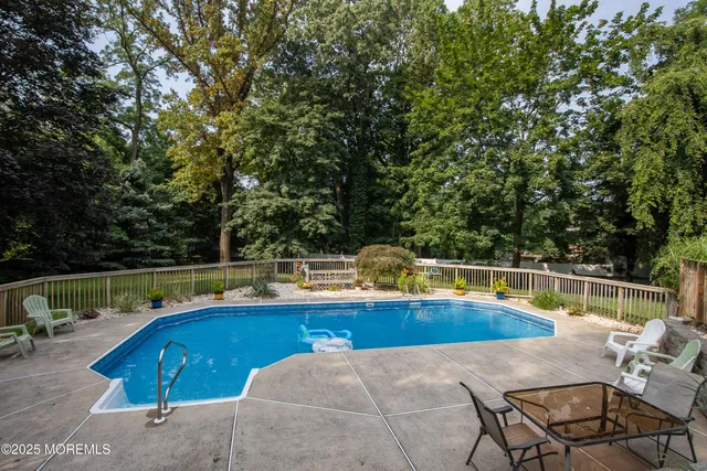 swimming pool view with a seating space