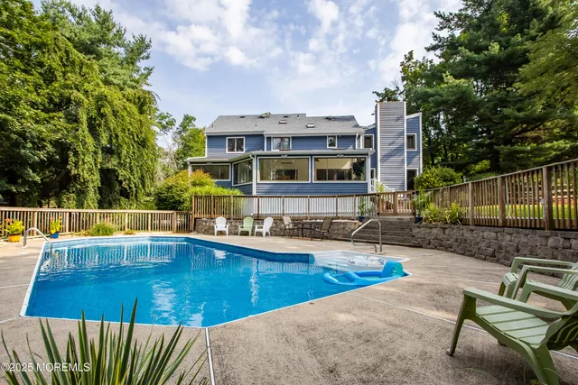 a view of swimming pool with chairs