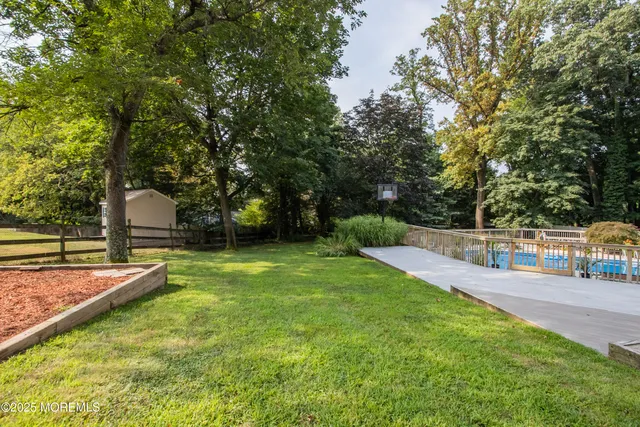 a view of a backyard with swimming pool
