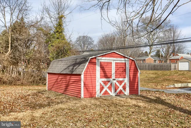 a view of a wooden door with a dry yard
