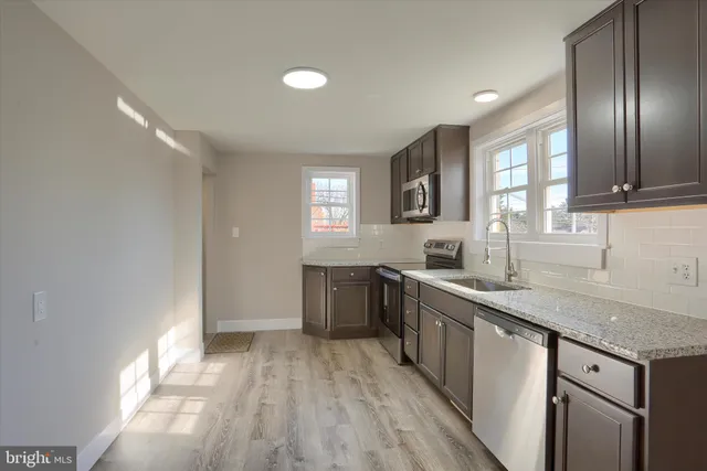 a kitchen with a sink stove and cabinets