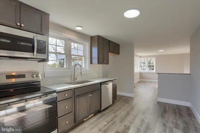 a kitchen with a sink stove and microwave