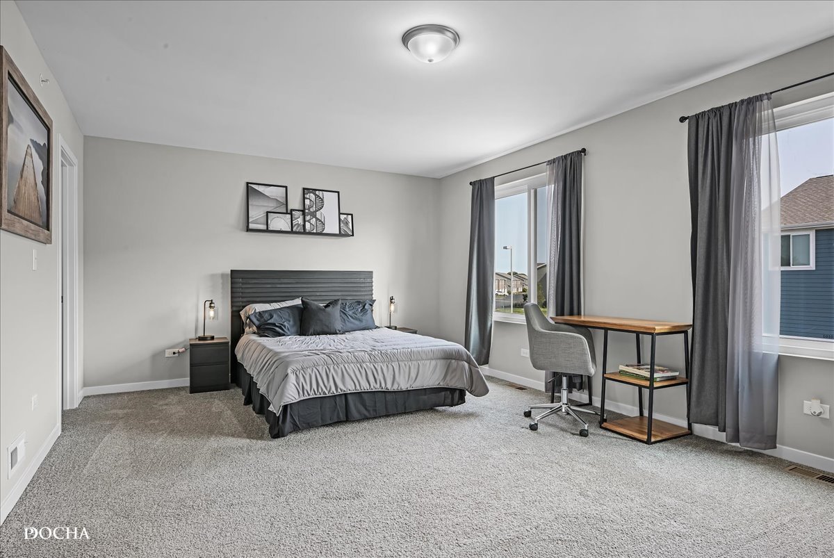 1232 Gillespie Lane Yorkville, IL 60560 - Photo 9 of 17 a spacious bedroom with a bed and a desk