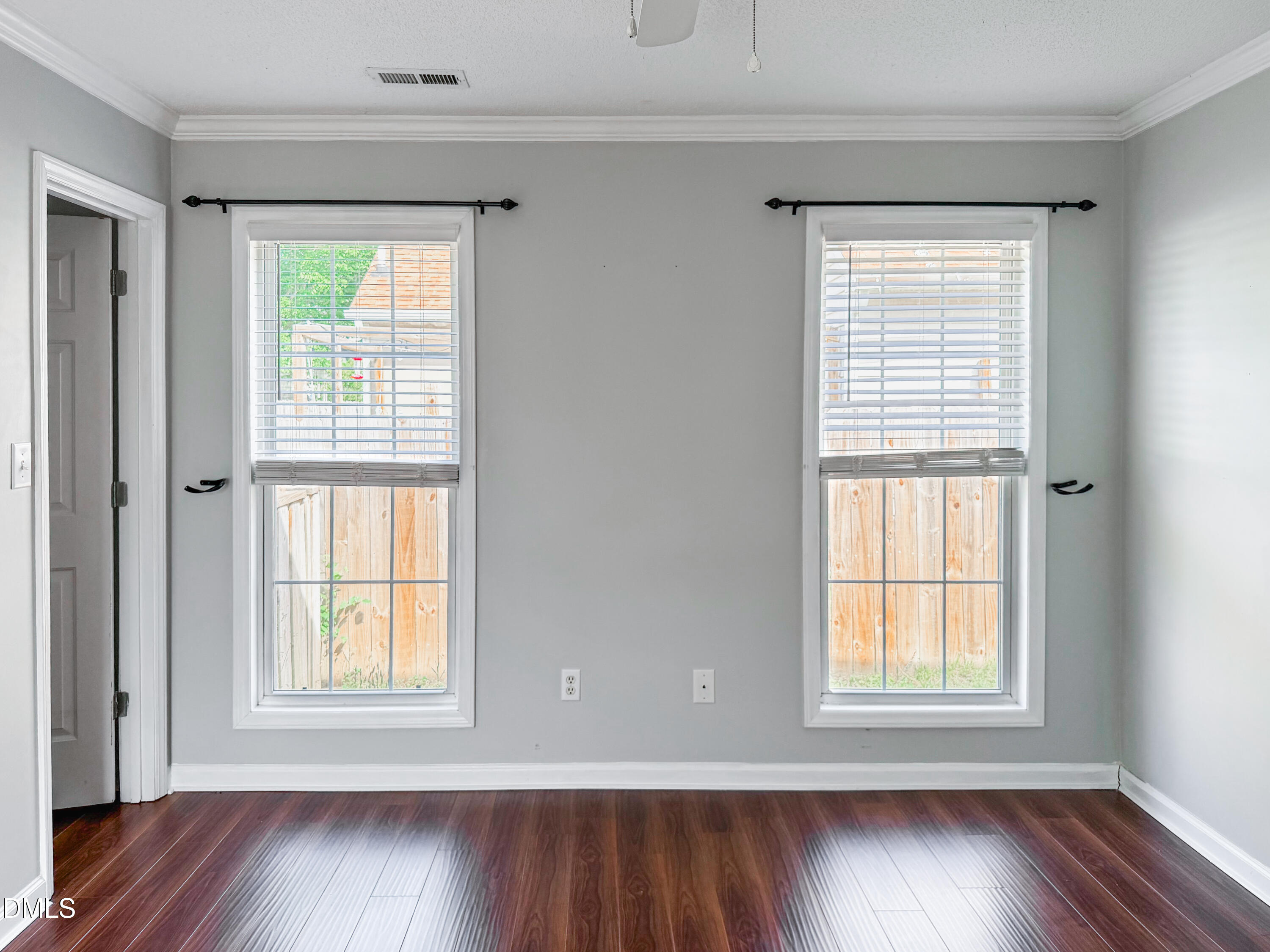 6304 Forest Ridge Drive Durham, NC 27713 - Photo 16 of 29 a view of an empty room with wooden floor and a window