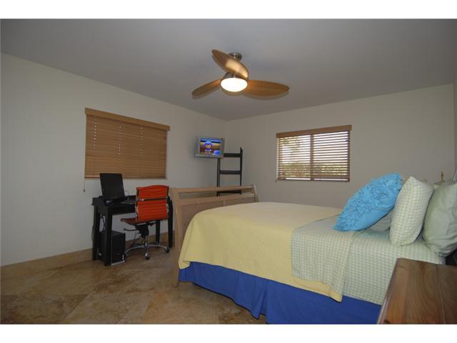 1900 Sharon Street Boca Raton, FL 33486 - Photo 12 of 21 a bedroom with a bed and a chandelier