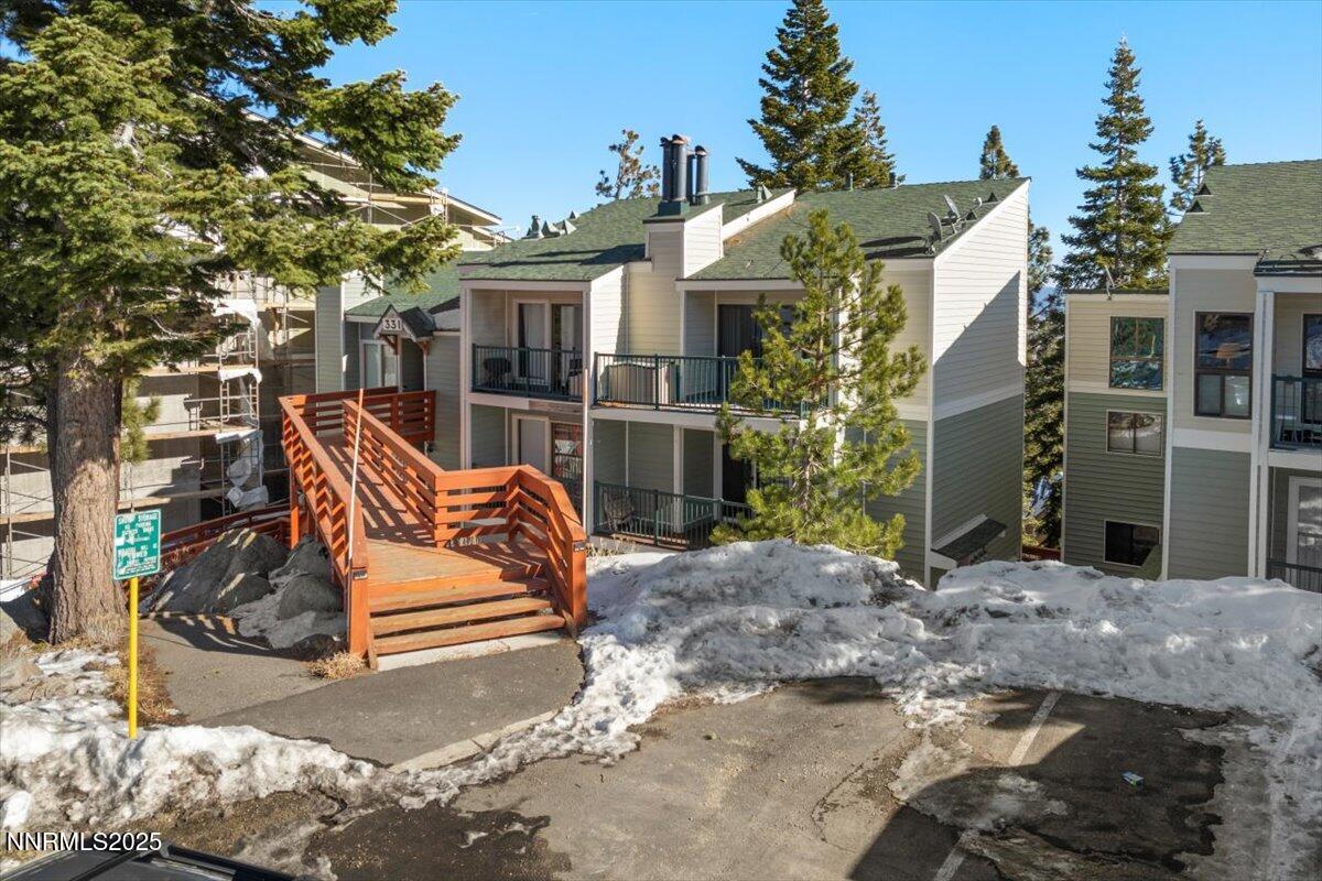 a view of a wooden chairs and bench in the backyard