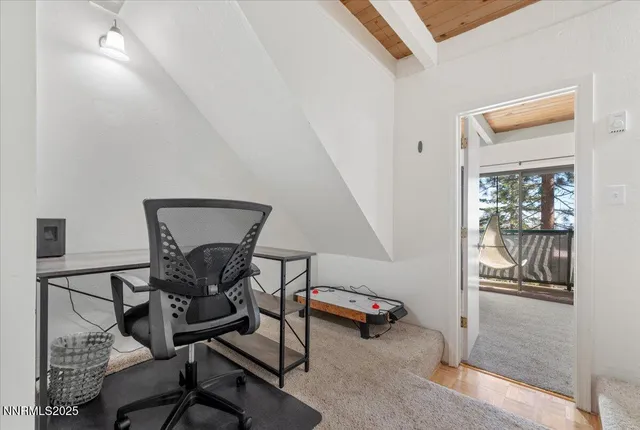 a view of a hallway with workspace and a window