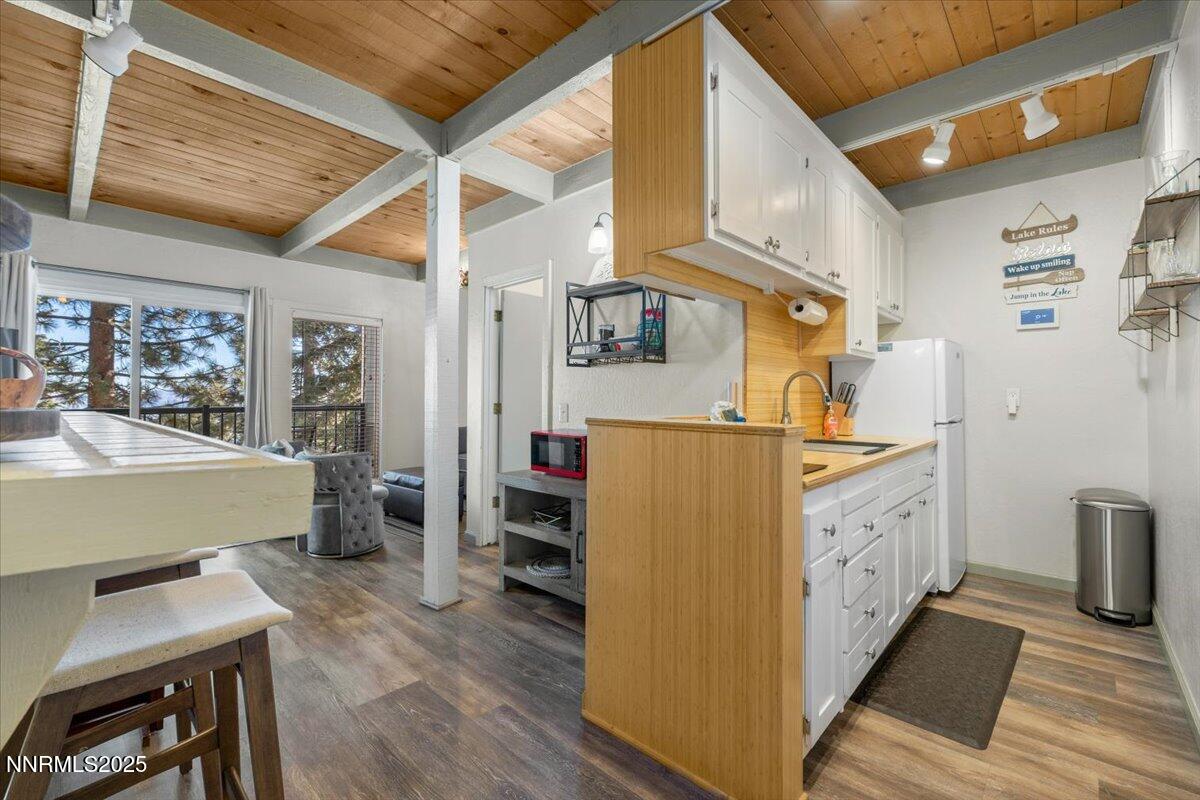 331 Tramway Drive, Unit 4 Stateline, NV 89449 - Photo 4 of 18 a kitchen with sink cabinets and wooden floor