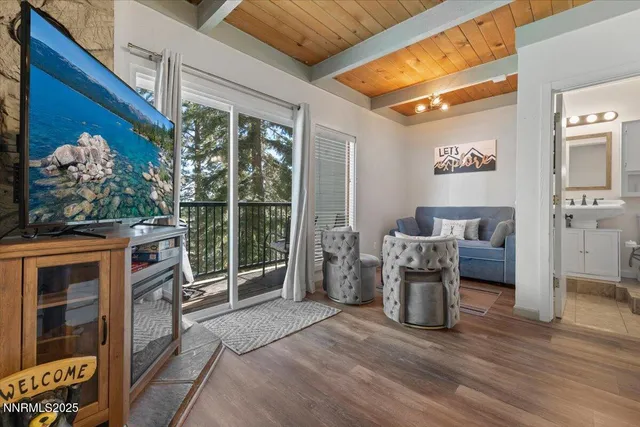 a view of a livingroom with furniture and a floor to ceiling window
