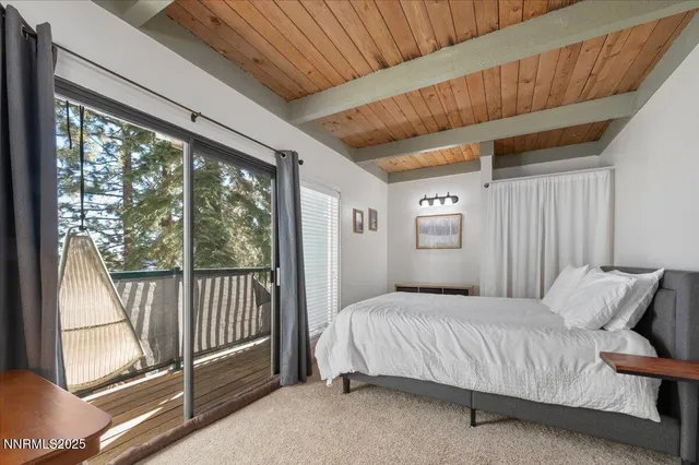 a bedroom with a large bed and a large window