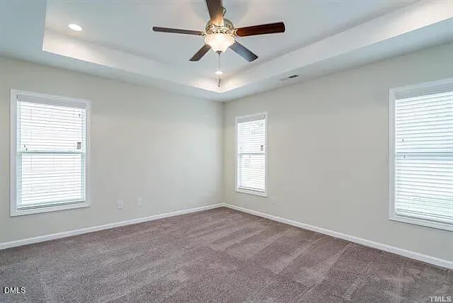 an empty room with closet and a chandelier fan