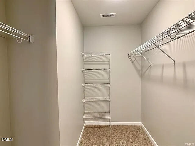 134 West Lumber Court Clayton, NC 27520 - Photo 17 of 23 a view of walk in closet with empty racks