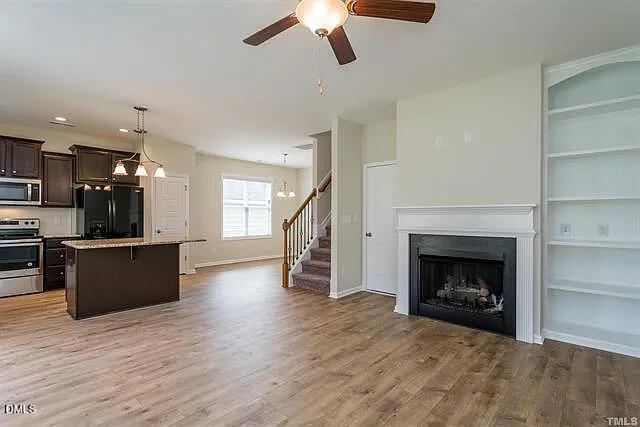 134 West Lumber Court Clayton, NC 27520 - Photo 4 of 23 a view of a kitchen and empty room with wooden floor
