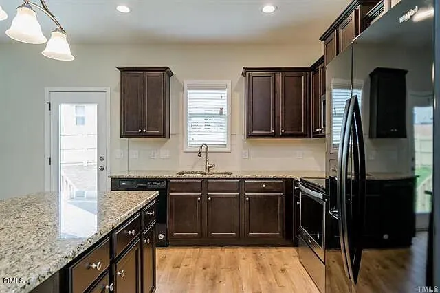 a kitchen with a sink stove and refrigerator