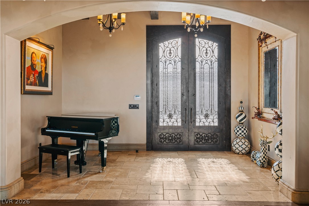 1123 Christian Road Henderson, NV 89002 - Photo 10 of 94 Ornate wrought iron doors grace the entry, set within a grand arched entryway.