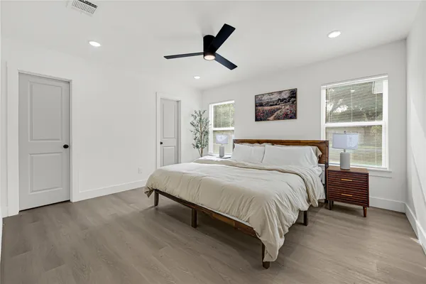 a spacious bedroom with a bed and a window