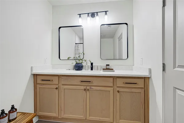 a bathroom with double vanity sink and a mirror