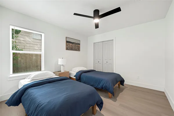 a bedroom with two beds and a window