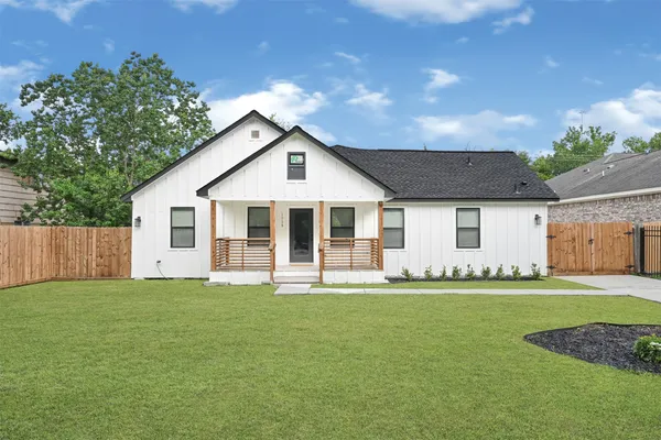 a big house with a big yard and large trees