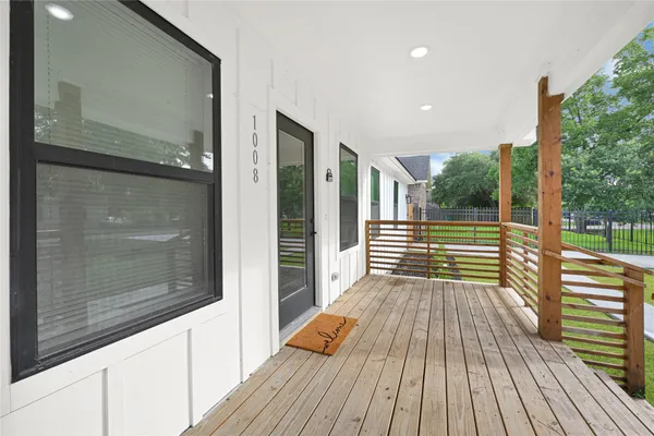 a view of deck with a floor to ceiling window and wooden floor