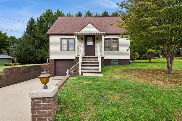 a front view of a house with a yard