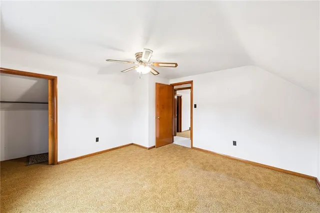 a view of a room with closet and chandelier fan