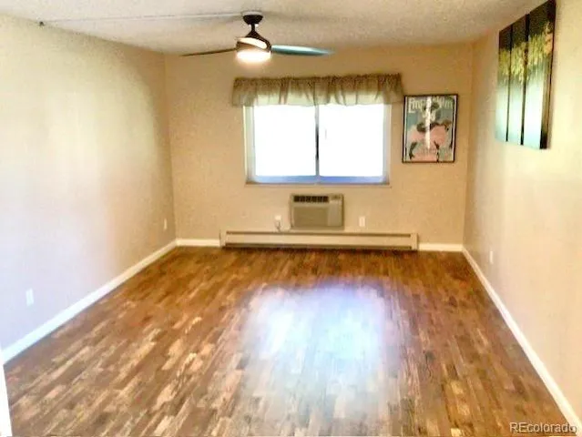 a view of a room with wooden floor and window