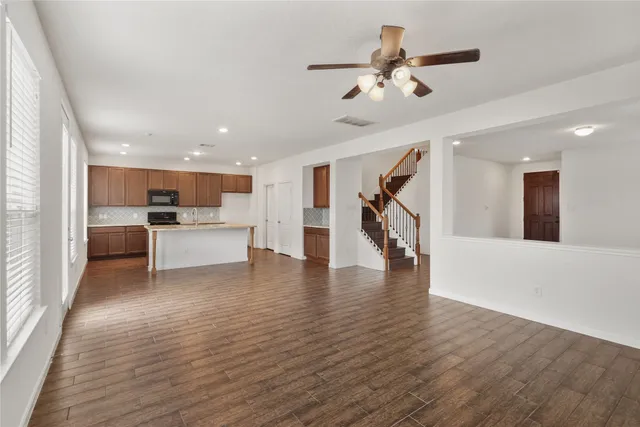 a view of a kitchen with a sink cabinets and wooden floor