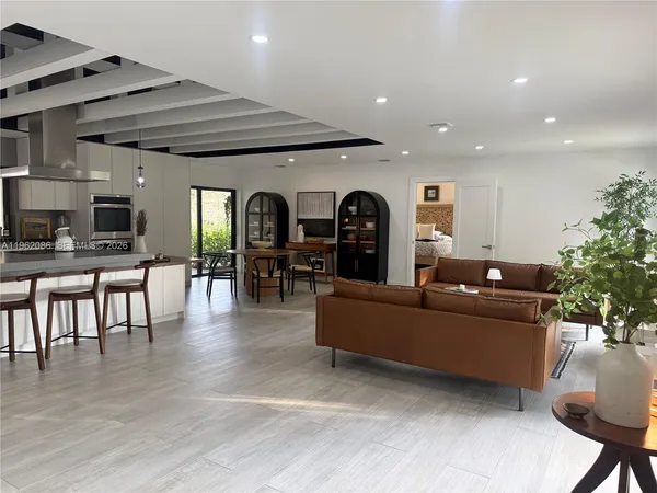 a living room with furniture and kitchen view