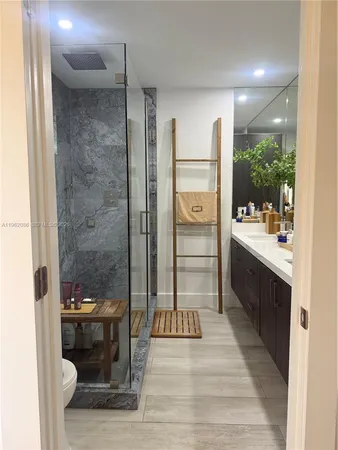 a bathroom with a toilet and a shower