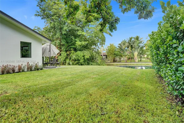 a front view of house with a garden and patio