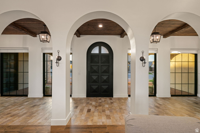 4871 South Homestead Way Washington, UT 84780 - Photo 19 of 151 Entryway with a wood ceiling with exposed beams, arched walkways, a chandelier, and light wood-type flooring