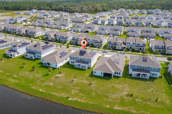 a aerial view of houses with yard