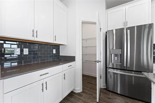 a view of kitchen and hall with wooden floor