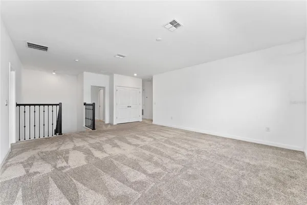 a view of an empty room with a kitchen